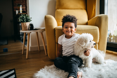 Happy toddler with white dog