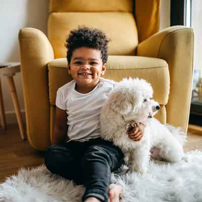 happy toddler with dog