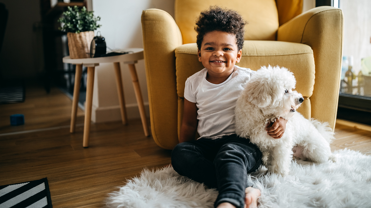 Cute toddler with small white dog