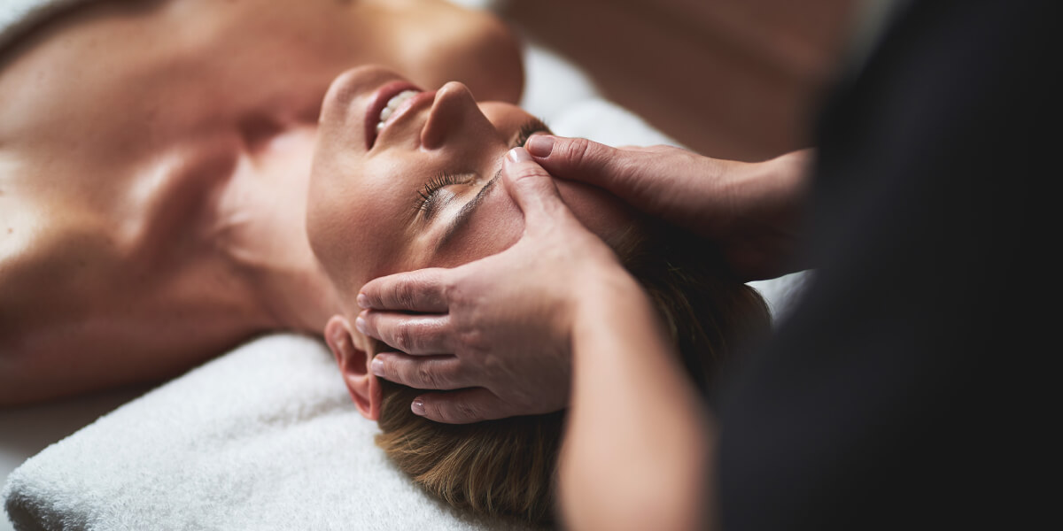 Woman receiving a relaxing head massage