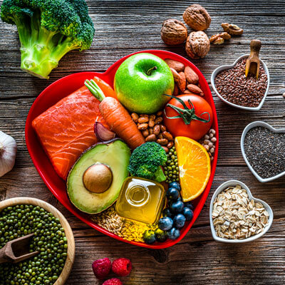 Healthy food on a wooden table in heart-shaped bowls