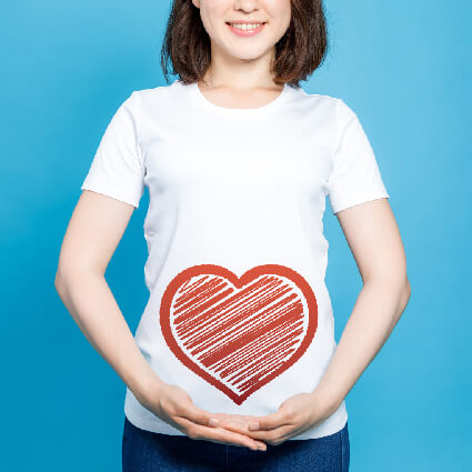 Heart over womans stomach clasped hands