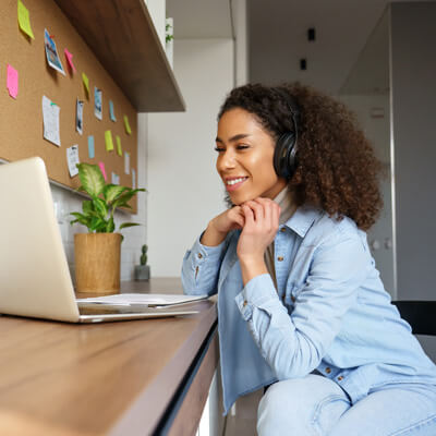 Woman smiling while listening to headphones