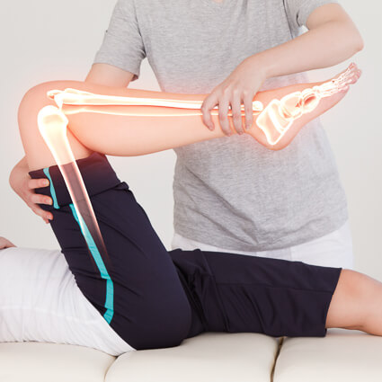 Illustration of leg bones on woman stretching her knee