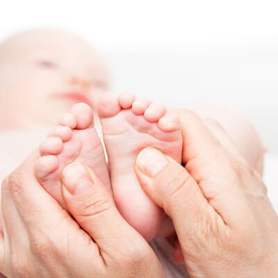 baby getting a foot massage