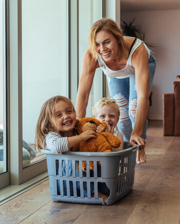 Smiling mom and two young children