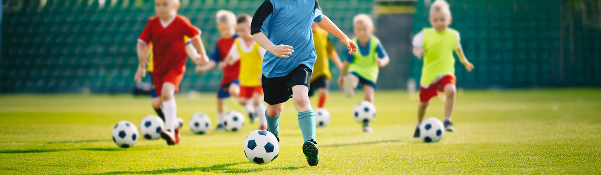 Kids playing soccer together