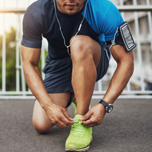 Man lacing up shoes before running