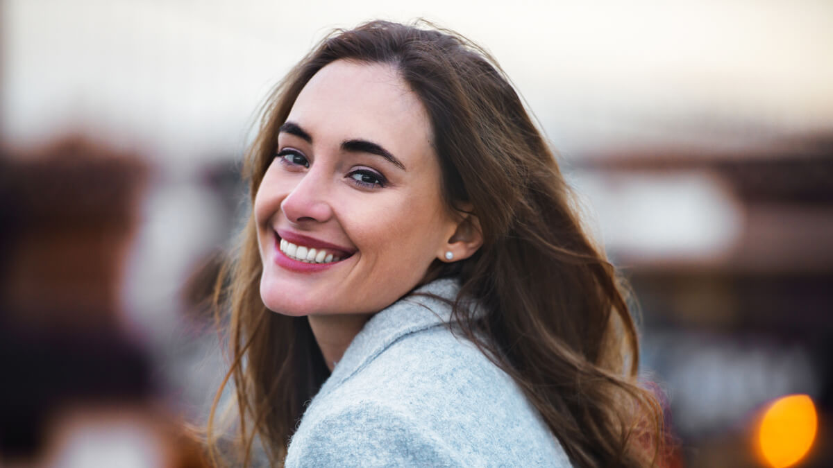 Woman smiling over her shoulder