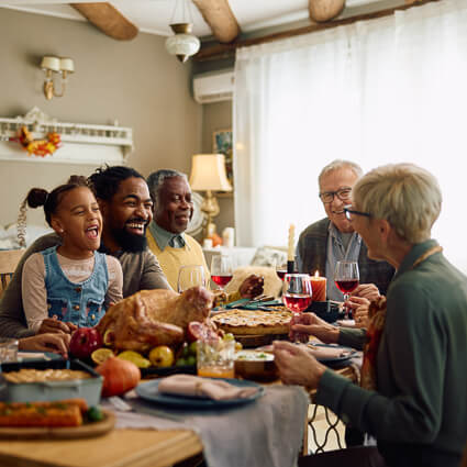large family eating meal together at table