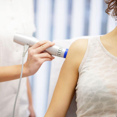 person getting laser therapy on arm