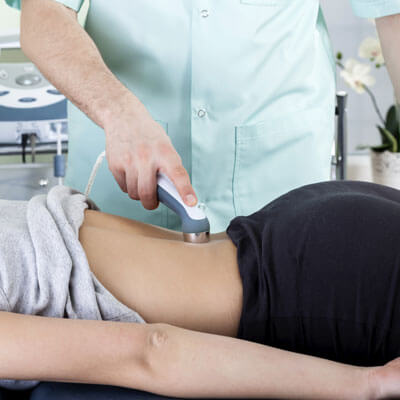 woman receiving laser therapy on her lower back
