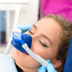 Young woman wearing dental sedation mask