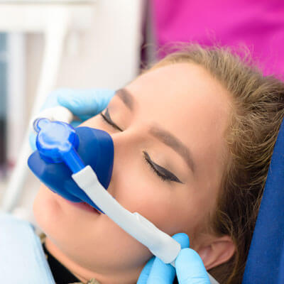 Woman wearing dental sedation mask