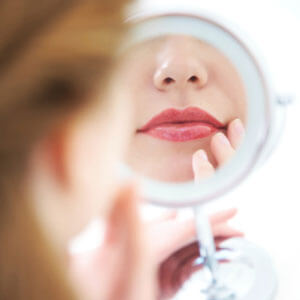 Woman looking in mirror