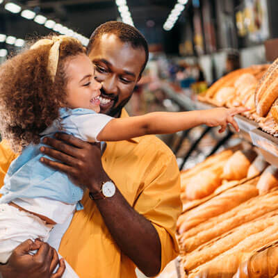 little girl and dad choosing bread