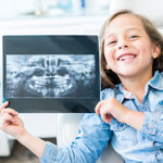 Little girl holding dental x-ray