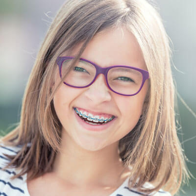 little girl smiling with braces