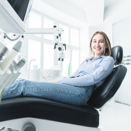 smiling person sitting in dental chair