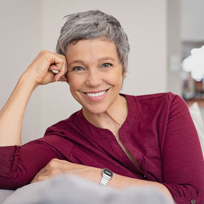 mature woman leaning on couch