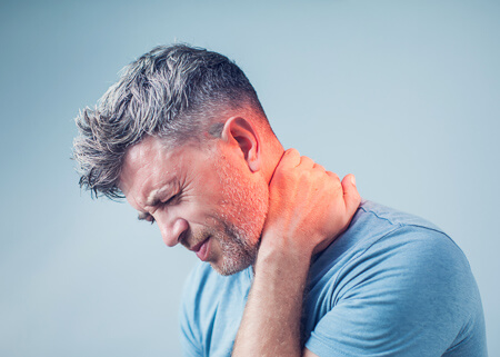 Man holding neck in pain