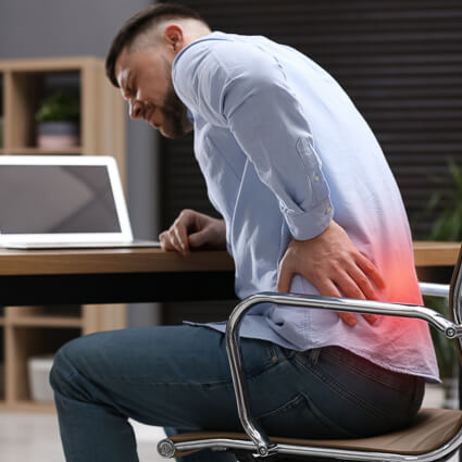 Man at work with intense lower back pain
