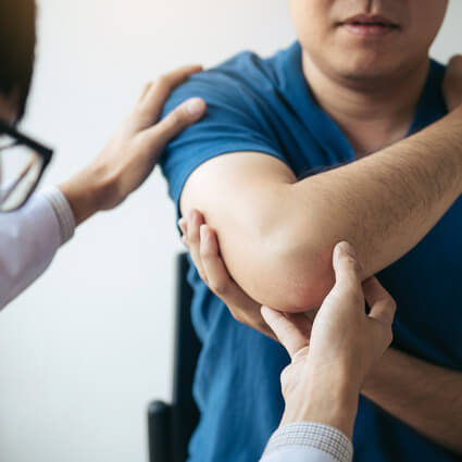 patient having elbow examined