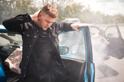 man exiting car after wreck