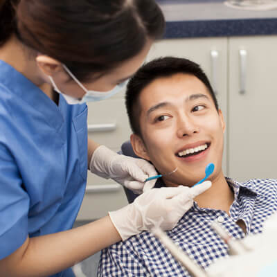 man having teeth examined