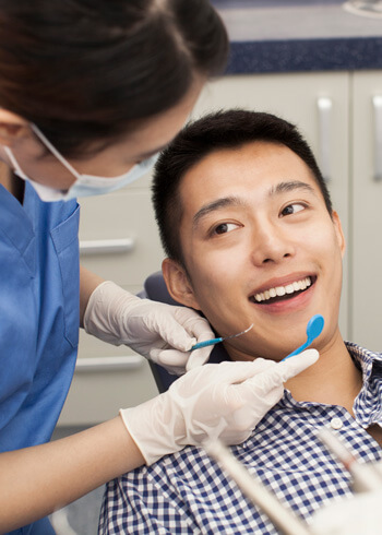 man having teeth examined