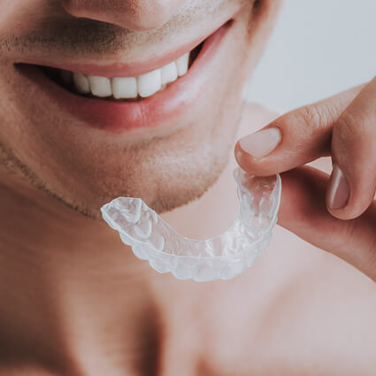 Person holding mouthguard