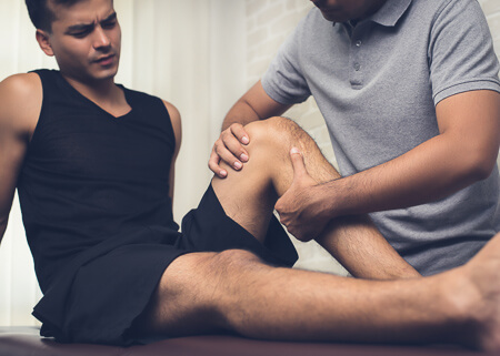 Man having leg adjusted by chiropractor