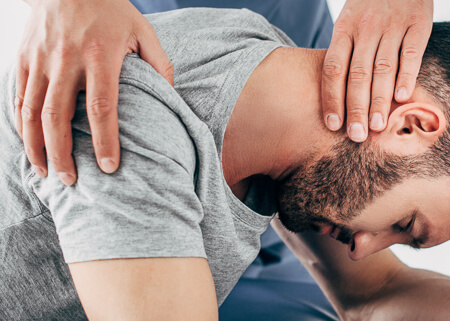 Chiropractor adjusting a patient's neck