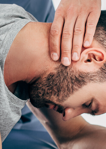Man having neck adjusted by chiropractor