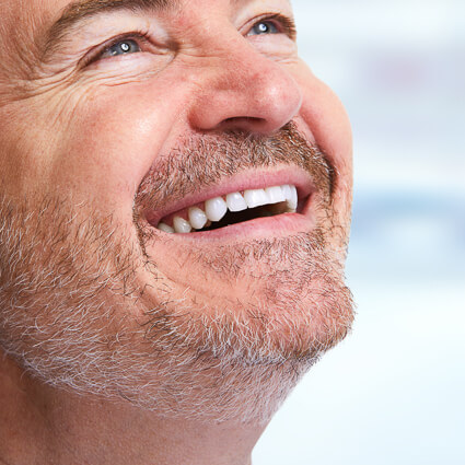man looking toward sky smiling