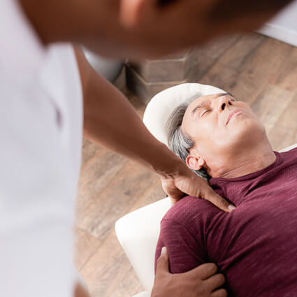Chiropractor performing professional trigger point therapy on a patient