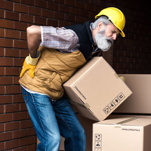 man moving boxes with back pain