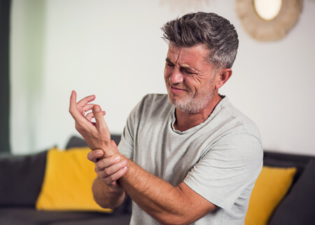 Patient experiencing wrist pain from carpal tunnel syndrome