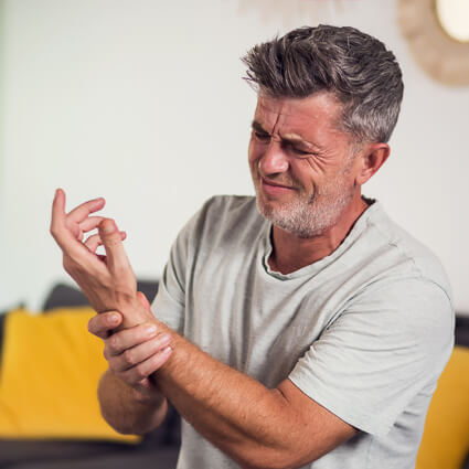 man holding wrist in pain