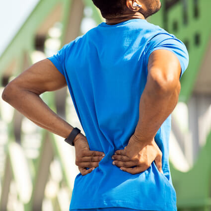 Man outside with back pain