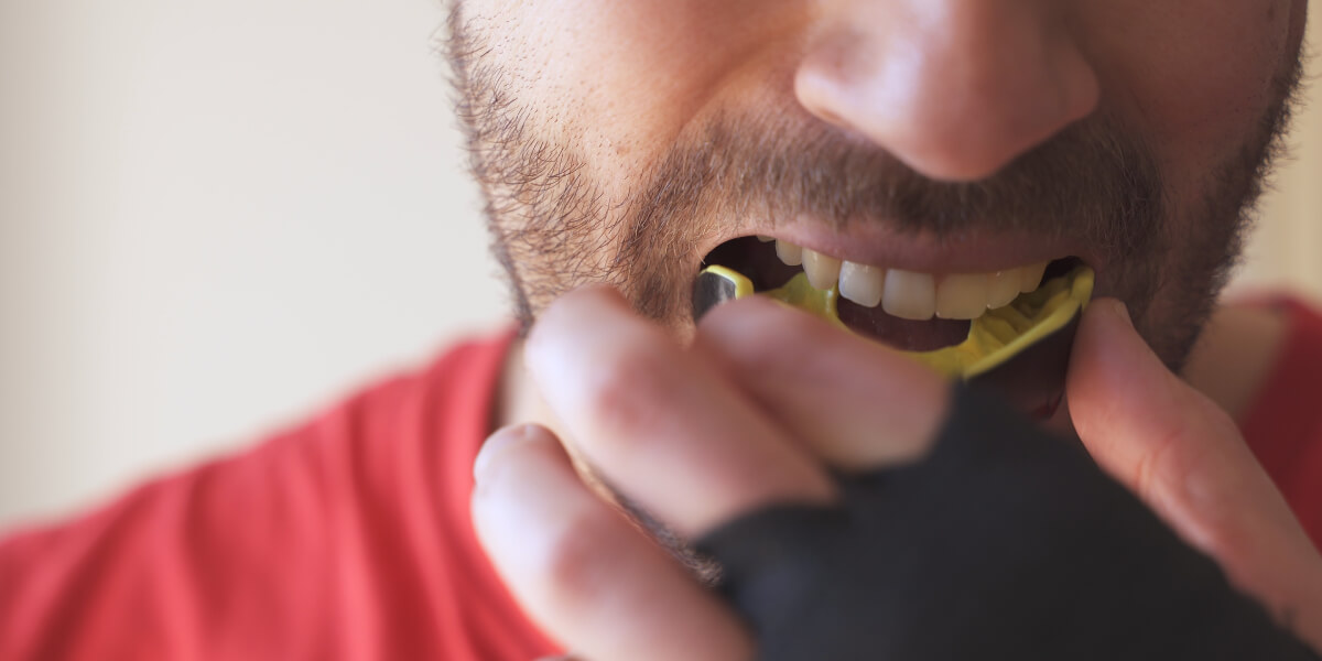 Athlete putting in mouthguard