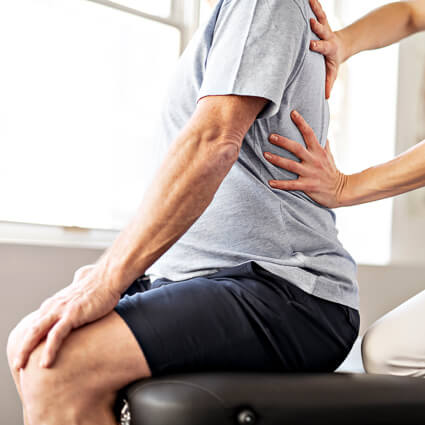 man having their back examined