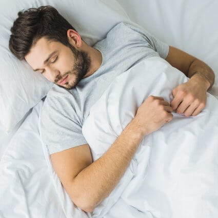 Man sleeping peacfully in bed
