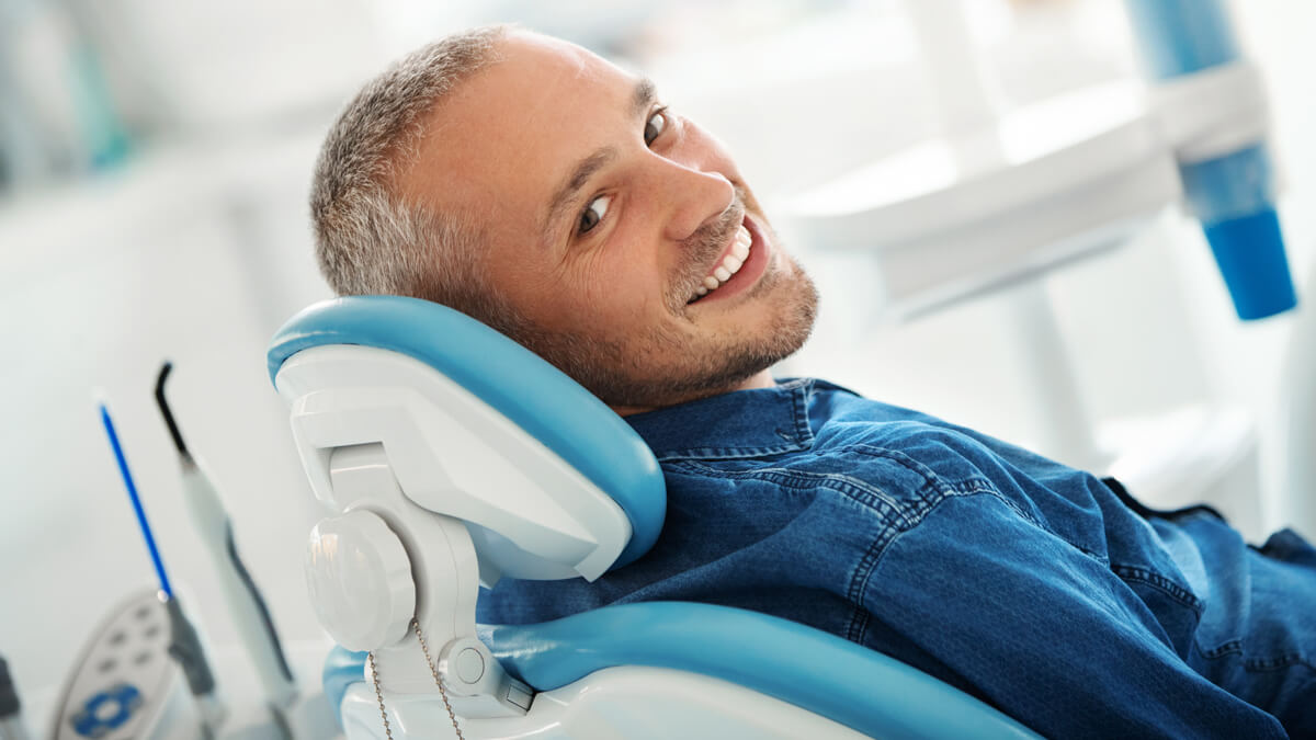 man smiling in dental chair 