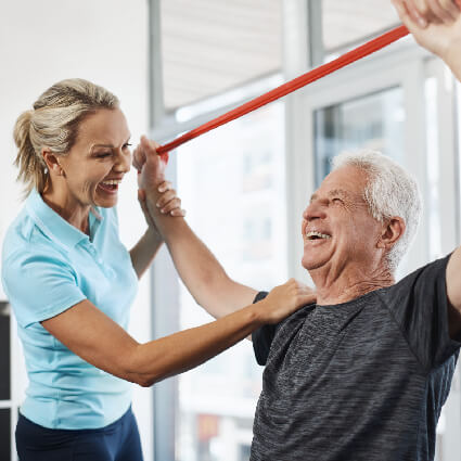 patient stretching band with their arms raised