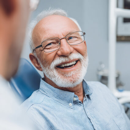manwith nice teeth smiling at the dentist