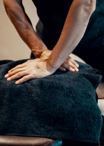 Chiropractic adjustment on female patient's back