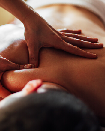 Massage therapist using soft tissue released technique on patient