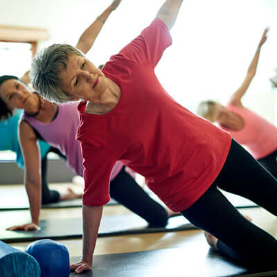 mature adult women in yoga class