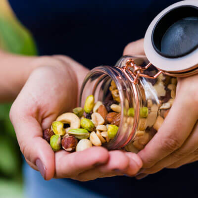 person eating mixed nuts